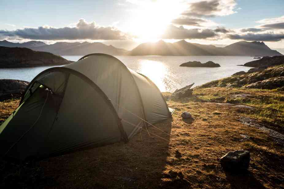 Photo of a tent pitched near a lake