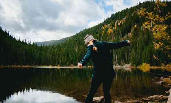 A girl standing by a lake